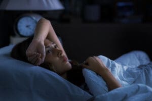 A woman worried about the relationship between anxiety and sleep