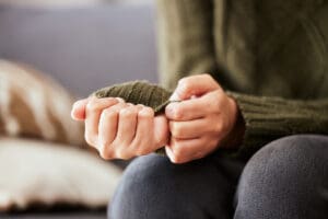 anxious women holding onto her sleeve looking for treatment